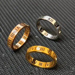 Close-up of three titanium rings featuring Roman numerals and sparkling cubic zirconia