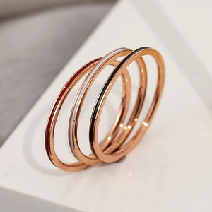 Three-piece rose gold stackable rings with colorful enamel bands for a modern style
