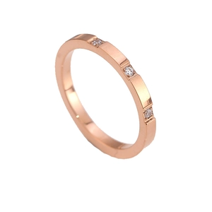 Minimalist rose gold titanium steel ring featuring three sparkling white diamonds inlay