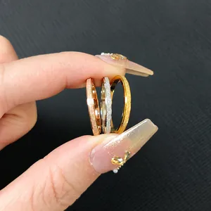 Detailed view of three-piece matte glitter thin rings in gold, silver, and rose gold finishes
