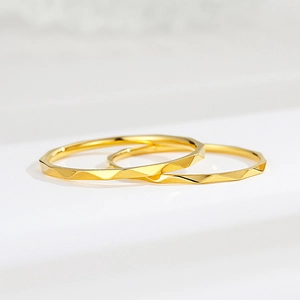Detailed macro view of thin rose gold titanium rings with geometric faceted texture