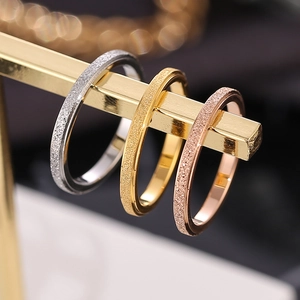 Minimalist matte titanium steel rings in silver, gold, and rose gold for layered stacking