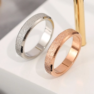 Frosted titanium steel couple rings in silver and rose gold with polished inner edges
