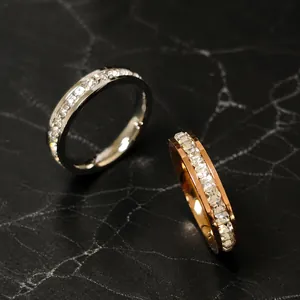 Close-up of silver and rose gold channel set eternity rings with sparkling crystals
