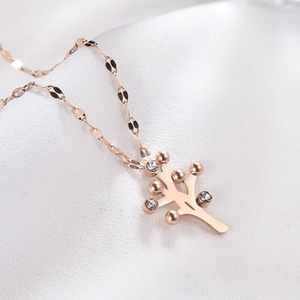 Close-up of rose gold Tree of Life pendant necklace with sparkling crystal accents