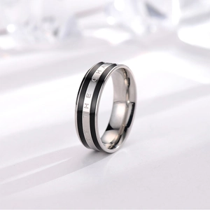 Detail of minimalist stainless steel ring featuring BE THE CHANGE motivational engraving