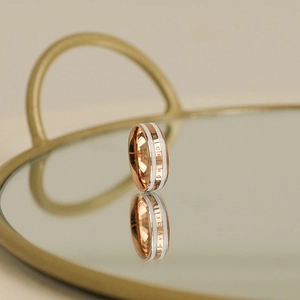 Modern 18k rose gold ring with white enamel and BE THE CHANGE engraving for women