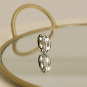 Polished stainless steel ring with white enamel inlay and Exchange engraving detail