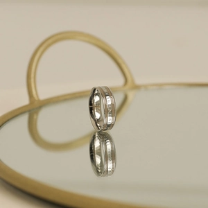 Macro detail of silver stainless steel ring with THE CHANGE engraving on mirror tray