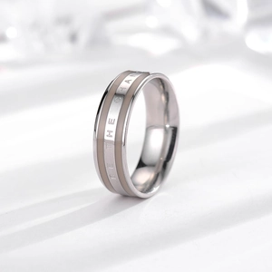 Detailed close-up of Be The Change engraving on a tricolor stainless steel ring