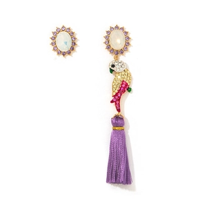 Macro detail of asymmetric colorful parrot earrings with long purple silk tassels and crystals