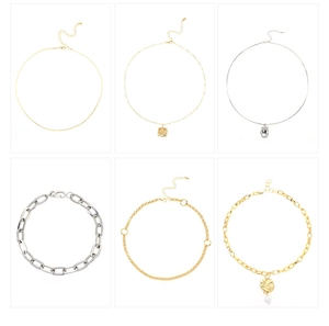 Dettaglio di collane multistrato in oro e argento con ciondoli geometrici e perle finte