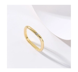Detail of square gold plated ring featuring a single sparkling center cubic zirconia