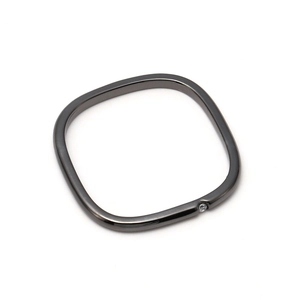 Detail of square gunmetal ring with a small cubic zirconia stone on a white background