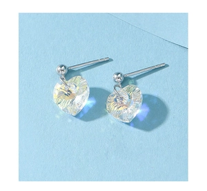 Macro shot of heart-shaped crystal earrings with iridescent coating and silver finish