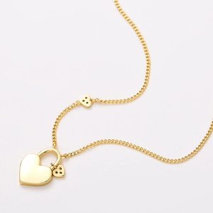 Polished golden heart lock necklace with dual mini heart charms on elegant thin chain