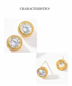 Macro shot of elegant round zircon stud earrings with golden textured metal borders