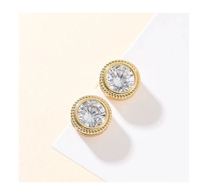 Detail of round cubic zirconia earrings with gold twisted rope edge and bright cutting