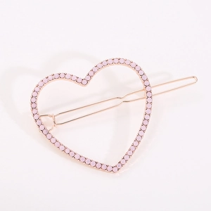 Eleganter herzförmiger Haarclip aus Roségold mit funkelnden rosa Strasssteinen auf Weiß