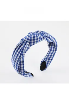 Detail of blue and white gingham fabric headband with top knot and non-slip inner lining