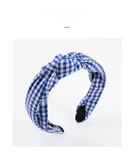 Detailed view of blue and white gingham wide headband with a top knotted design