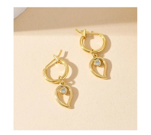Close-up of geometric S925 silver drop earrings with gold finish and sparkling zircon stones