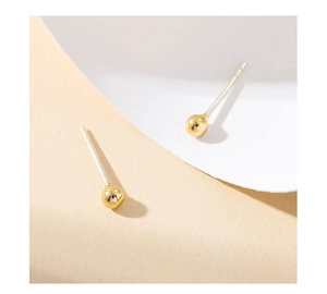 Minimalist gold ball stud earrings with S925 silver needles on a warm beige background