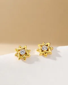 Detail of 3D geometric hexagram stud earrings with round cubic zirconia center and gold finish