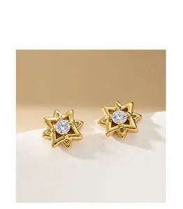 Detail of gold hexagram stud earrings with double star layers and zircon center stone