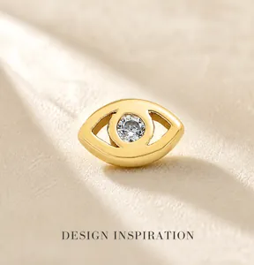Detail of gold evil eye pendant featuring a brilliant round white zircon stone centerpiece