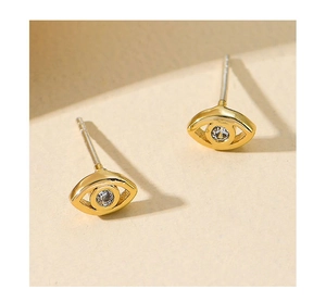 Macro shot of gold-plated S925 silver needle stud earrings featuring blue zircon devil eye
