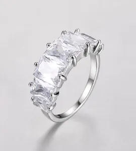 Detailed view of silver ring featuring five rectangular-cut cubic zirconia in claw setting