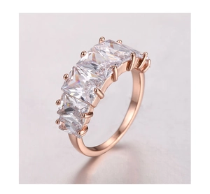Detail view of rose gold band with five rectangular zircon stones in prong setting