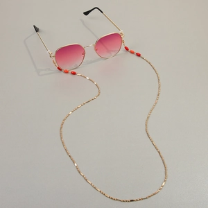 Chaîne de lunettes dorée élégante avec perles rouges et lunettes dégradées roses