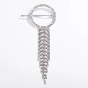 Close-up of silver geometric hair clip with sparkling rhinestone fringe and round crystal ring