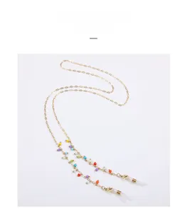 Detail of colorful beads on a gold alloy chain with lobster clasp and silicone loop