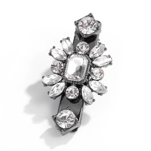 Detailed macro view of an elegant black alloy hair clip with clear crystal rhinestones