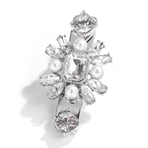 Detailed macro view of silver duckbill clip with marquise crystals and white pearls