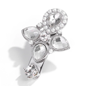 Detail shot of silver metal hair clip with cross design, rhinestones and faux pearls