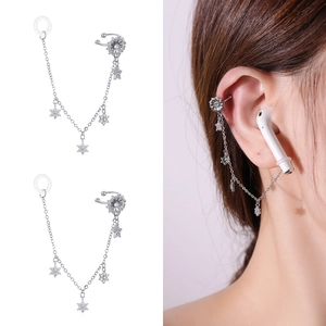 Detail view of silver snowflake anti-lost chain earrings for wireless headphones
