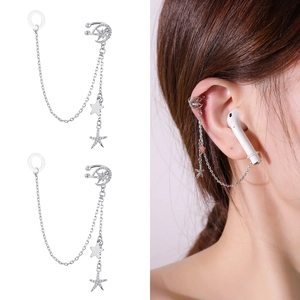 Detail view of silver anti-lost earring chains with moon and star zircon charms