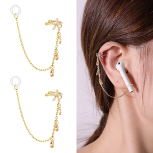 Detail view and model wearing a gold wireless earphone anti-loss chain with flower design