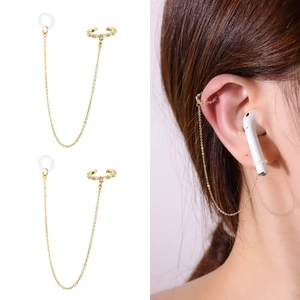 Close-up of gold ear cuff with zircon accents and anti-lost chain for wireless earbuds