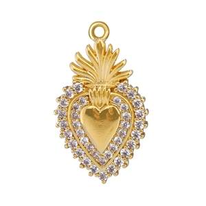 Detailed view of a gold heart pendant with sparkling crystals and sacred flame top