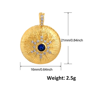 Detailed view of gold sunburst pendant with blue stone showing 21mm by 16mm dimensions