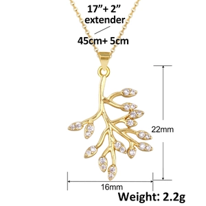 Detail view of 18K gold leaf pendant with zircon inlay and product measurements
