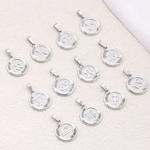 Set of 12 silver zodiac sign pendants with engraved symbols and radial borders