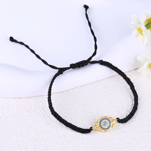 Handmade woven black rope bracelet with a gold-plated blue Evil Eye palm pendant
