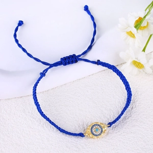 Handmade woven blue Evil Eye charm bracelet with gold-plated accents and crystal settings