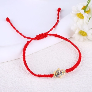 Detail of red woven Hamsa Hand bracelet with colorful micro-pave zircons and adjustable cord